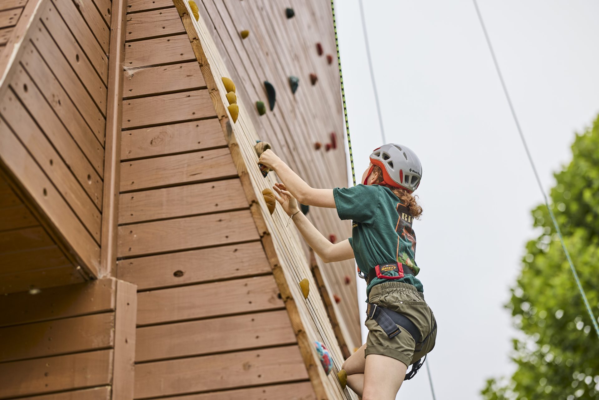 A scout on a climbing wall